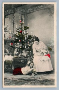 GIRL w/ DOLLS & TOY HORSE at DECORATED CHRISTMAS TREE ANTIQUE POSTCARD