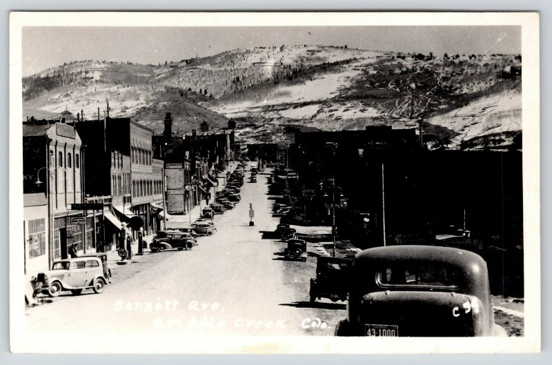 Cripple Creek CO~Bennett Avenue Garage~Gas Pumps on Sidewalk~1930s Cars~RPPC 