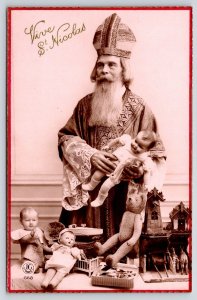 French Christmas Santa~St Nicolas Holds Baby Doll~Steiff Bear~Wind Up Boat~RPPC