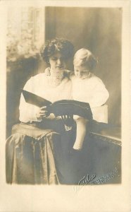 Postcard RPPC Illinois Chicago Woman reading book to child 23-2912