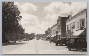 St Charles MN~Main St~1930s Cars~Olson Meat Market Truck Illegally Parked~RPPC 