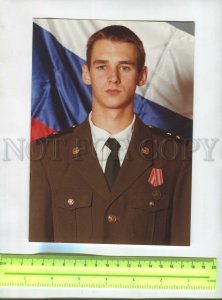 476289 RUSSIA young soldier on background Russian flag an award BIG photo