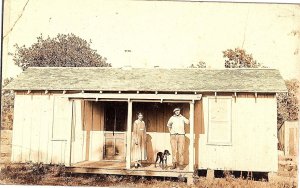 RPPC Photo Postcard Rustic Cabin with Couple & Dog Rural Americana