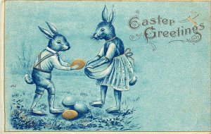Embossed Easter Postcard Ser.530 Blue Ink Dressed Rabbits gathering Gold Eggs