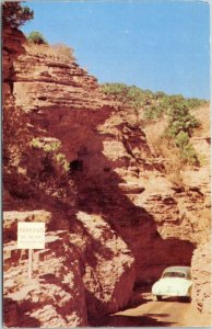 postcard Colorado - Old car driving through The Narrows to Cave of the Winds