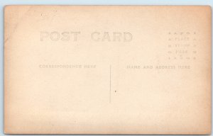 c1910s Outdoor Men RPPC Windy Fat Guy Suspenders Farm Fence Tree Sky Photo A254