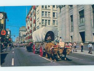 Pre-1980 OXEN PULLING CHUCKWAGON BY SHOPS ON STREET Calgary Alberta AB F0473