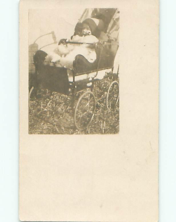 Pre-1917 rppc BABY WEARING WINTER HAT IN ANTIQUE CARRIAGE STROLLER o2374