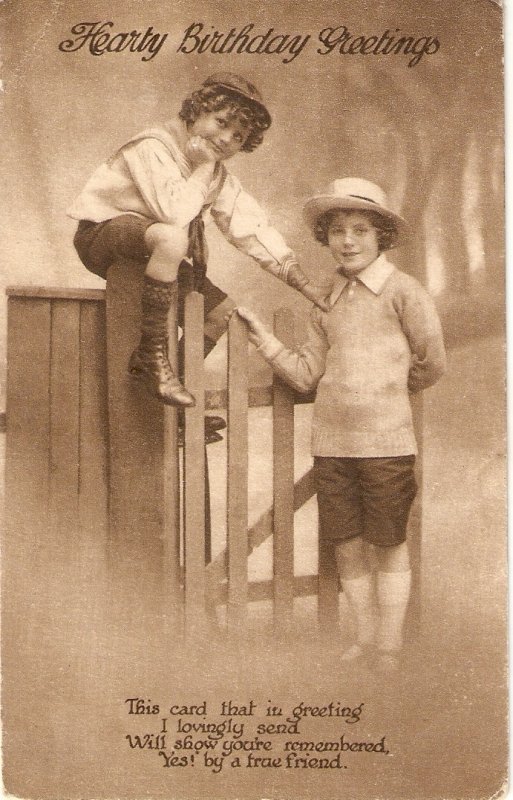 Boy and girl at a fence. Birthday message Old vintage English postcard