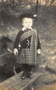 Young Scottish Boy on a Bench with Kilts Real Photo Postcard