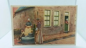 Vintage Postcard Dutch Women Collecting Water From the Local Waterpump Holland