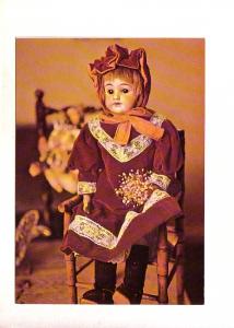 Doll with Red HAir and Bouquet Wearing Purple Dress