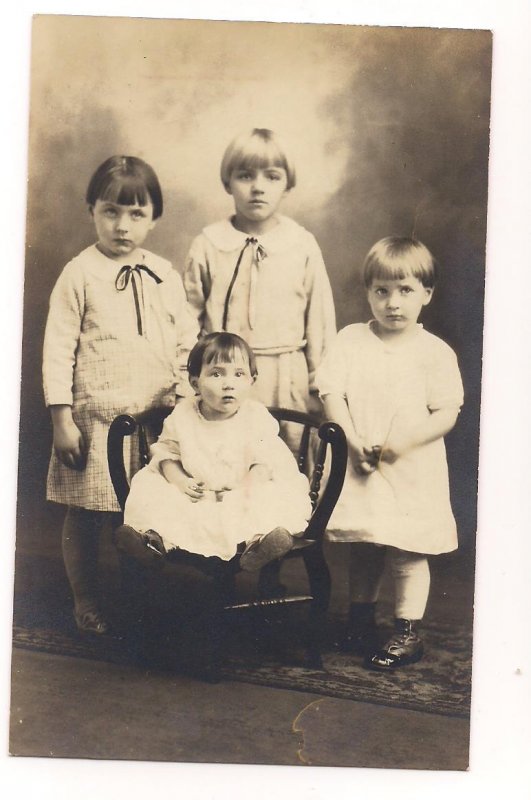 RPPC of 4 children posed in Studio