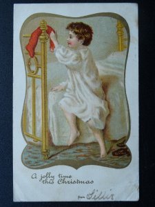 A JOLLY TIME THIS CHRISTMAS Child With Christmas Stocking c1902 UB Postcard