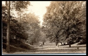 1908 Man and Woman Seated on a Tree Stump Galion OH Real Photo Postcard