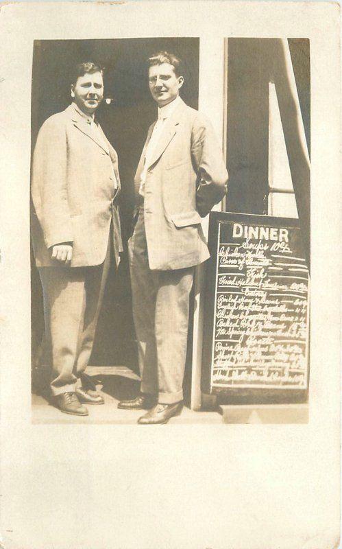 C-1910 2 men suits Restaurant Owners Sandwich Board menu RPPC postcard 6617