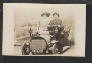 Man,Woman in Automobile Postcard 