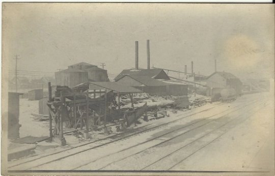Vintage Real Photograph Postcard RPPC Lumber Yard with Railroad (Train) Tracks