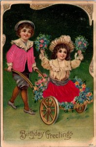 Silk Birthday Greetings Postcard Boy Pushing Girl in Cart with Flowers