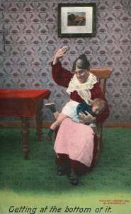 Vintage Postcard 1910's Mother Slaps Baby In Her Lap Getting At The Bottom Of It