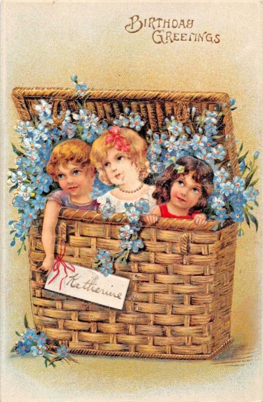 BIRTHDAY GREETINGS 1910s EMBOSSED POSTCARD 3 GIRLS IN GILT BASKET-KATHERINE TAG