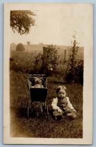 c1910s Little Boy Teddy Bear On Stroller Scene Field RPPC Photo Antique Postcard
