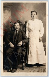 c1910s Middle Aged Married Couple RPPC Man Woman Lady Wood Chair Real Photo A193