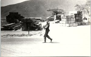 1960s VIETNAM WAR ARMY CAMP LUMBER STACKS SOLDIER PHOTO RPPC POSTCARD 43-185