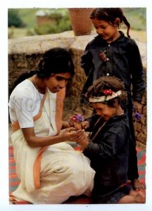 495697 1989 YOUNG CHURCHES Children visiting an Indian sister in Nepal postcard