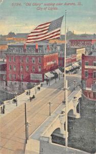 Aurora IL Storefronts Bridge Old Glory over City of Lights Postcard