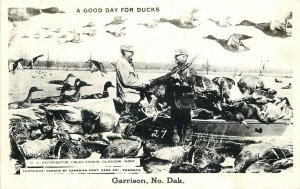 Postcard RPPC North Dakota Garrison Duck hunting exaggeration 1940s 23-2582