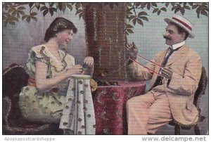 Romantic Couple Sitting At Table With Yarn