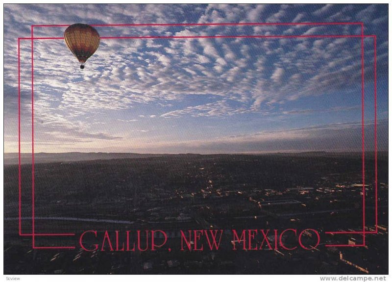 A hot air balloon floats peacefully over Gallup, New Mexico, 40-60s