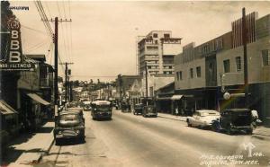 1953 NOGALES SONORA MEXICO Av A Obregon Autos Trucks Bus RPPC POSTCARD 7424