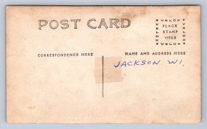 J90/ Jackson Wisconsin RPPC Postcard c1910 Store Delivery Wagon Man 298