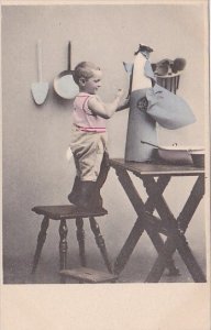 Young Boy Standing On Stool Unwrapping Something ???