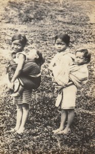 RP: PHILIPPINES , 00-10s ; Kids carrying Babies