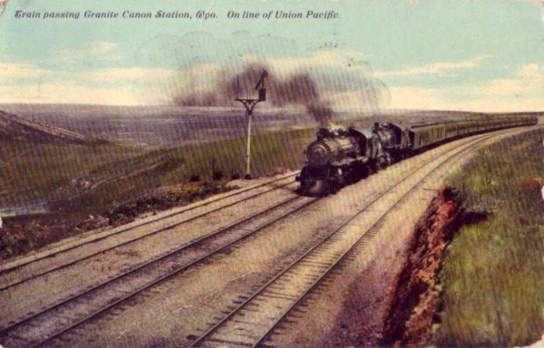 TRAIN PASSING GRANITE CANON STATION, WY. ON LINE OF UNION PACIFIC 1911