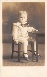 Little boy in chair Child, People Photo Writing on back 