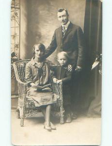 Pre-1949 rppc MOM HOLDING BOOK WITH SON & DAD o2137