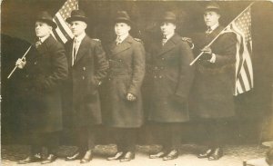 Postcard RPPC C-1910 Well dressed men hats patriotic flags interior 23-11606