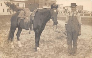 RPPC SADDLED HORSE & MAN TOWN VIEW REAL PHOTO POSTCARD (c. 1910)