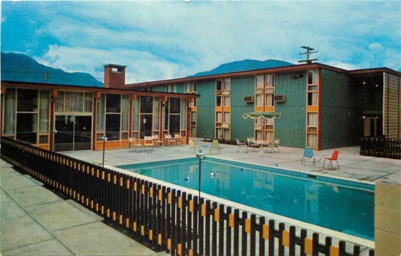 Revelstoke BC~McGregor Motor Inn~Swimming Pool Over Railing~1960s Postcard 