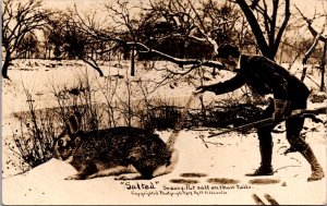 Exaggeration RPPC Hunter Putting Salt on Giant Bunny Rabbit Tail Rifle Winter