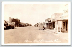 Kanorado KS~Main Street~Short Lunch~Greyhound Bus Stop~Farmers Lumber~1940 RPPC 