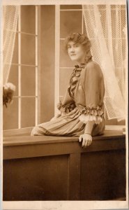 Real Photo Postcard Woman Sitting on Window Ledge in a Photo Studio~135968