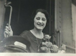 1921 Real Photo Postcard RPPC Woman on Riding Train Flowers Conductor Hat