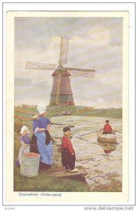 Mother and children at waterfront watching boy rowing boat, Windmill, Overzet...