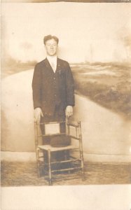1910s RPPC Real Photo Postcard Man In Suit Standing With Chair
