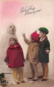 RPPC NEW YEAR HOLIDAY SNOWMAN CHILDREN NETHERLANDS STUDIO REAL PHOTO POSTCARD